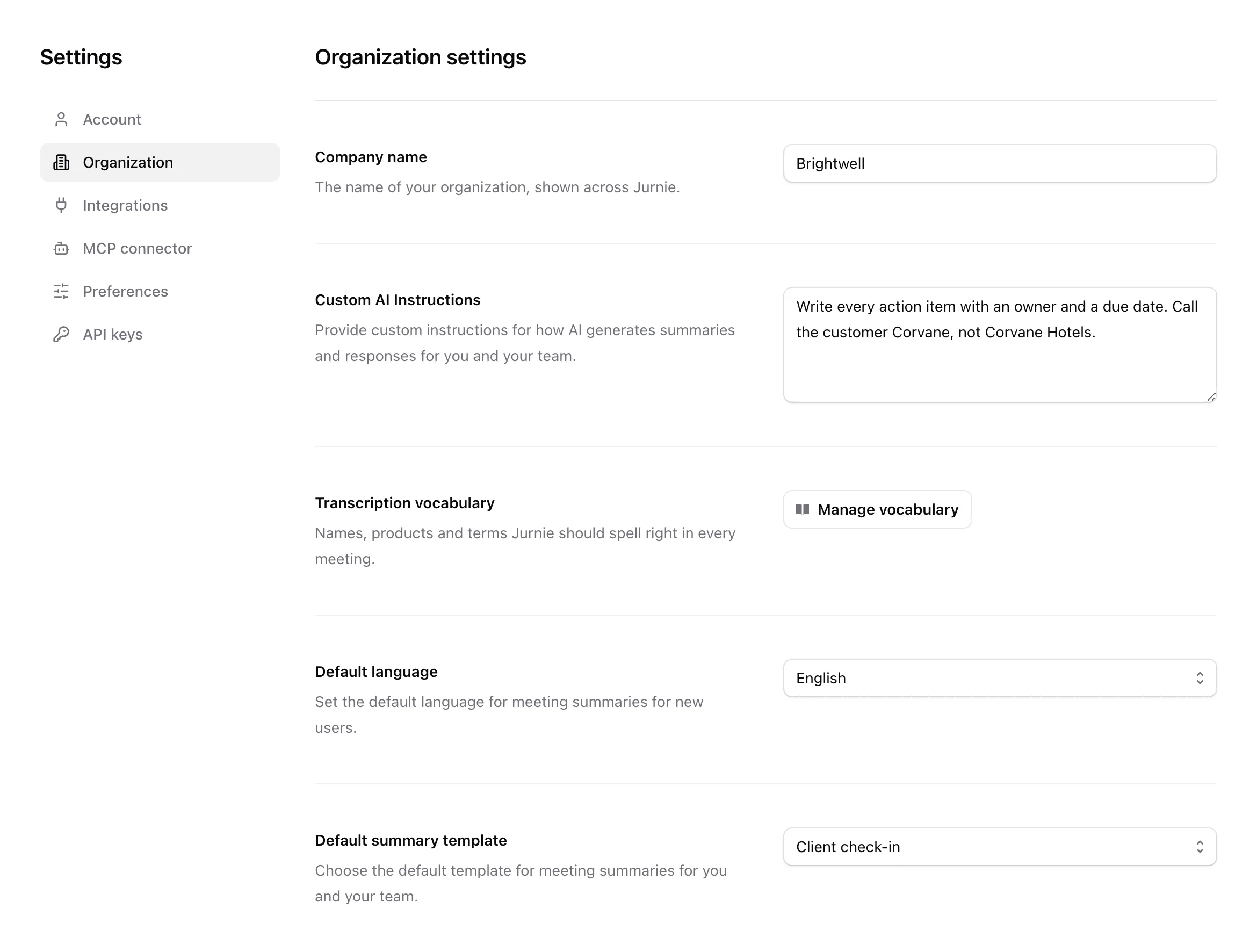 The Organization tab in Settings, with company name, custom AI instructions, vocabulary, default language and default template